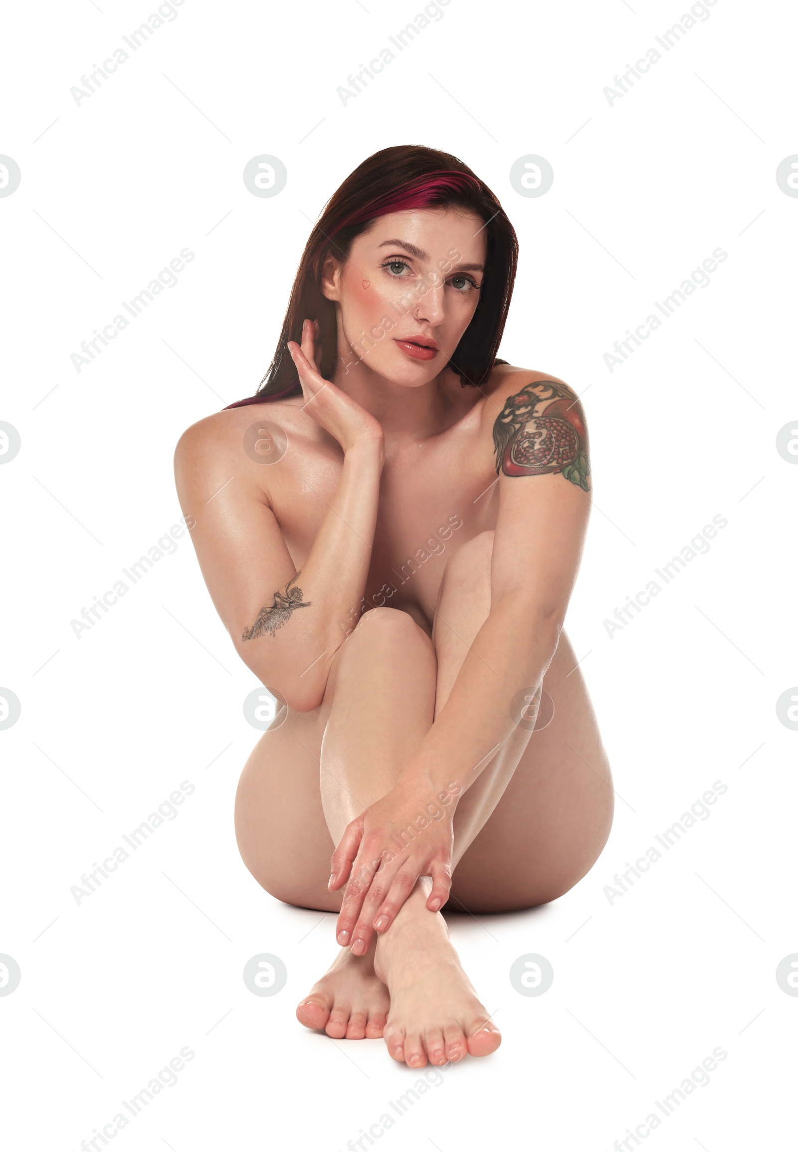 Photo of Beautiful nude woman with tattoos posing on white background