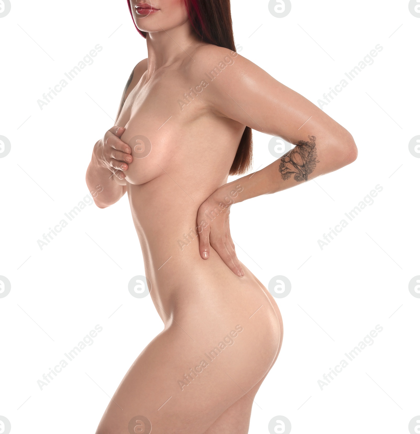 Photo of Nude woman with tattoos posing on white background, closeup