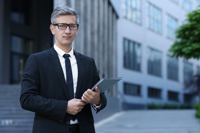 International relations. Diplomat with clipboard in suit outdoors, space for text