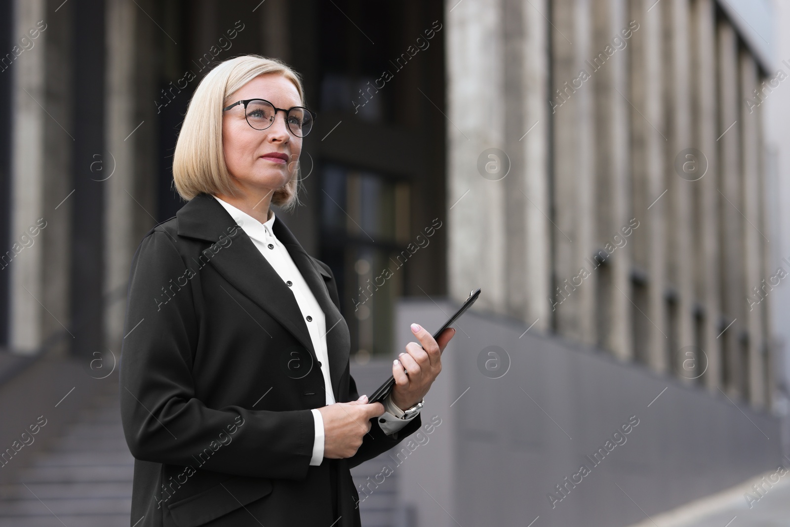 Photo of International relations. Diplomat with clipboard in suit outdoors, space for text