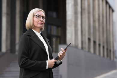 International relations. Diplomat with clipboard in suit outdoors, space for text