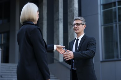 International relations. Diplomats shaking hands during meeting outdoors