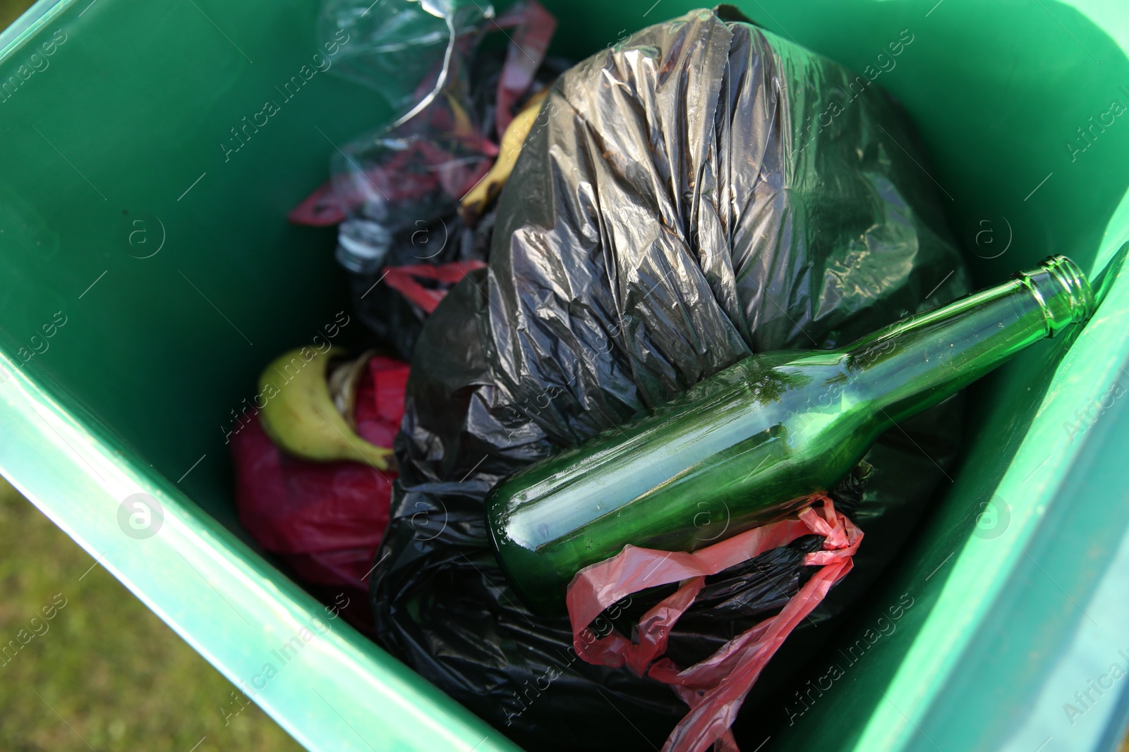 Photo of Trash bags full of garbage in bin outdoors, above view