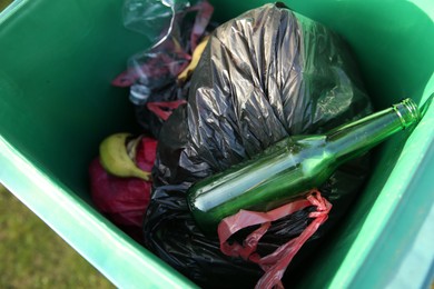 Photo of Trash bags full of garbage in bin outdoors, above view