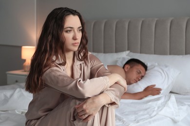 Offended couple after quarrel in bedroom. Relationship problem