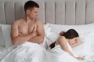 Offended couple after quarrel in bed. Relationship problem