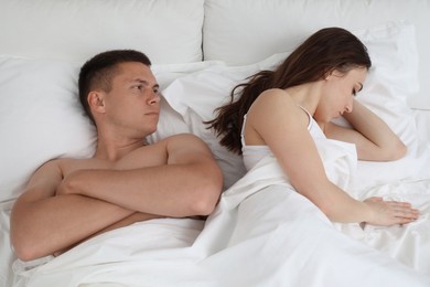 Offended couple after quarrel in bed, top view. Relationship problem