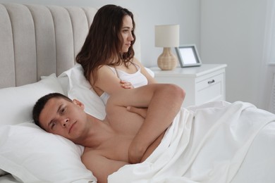 Offended couple after quarrel in bed. Relationship problem