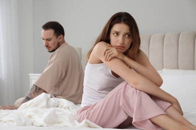 Offended couple after quarrel in bedroom. Relationship problem