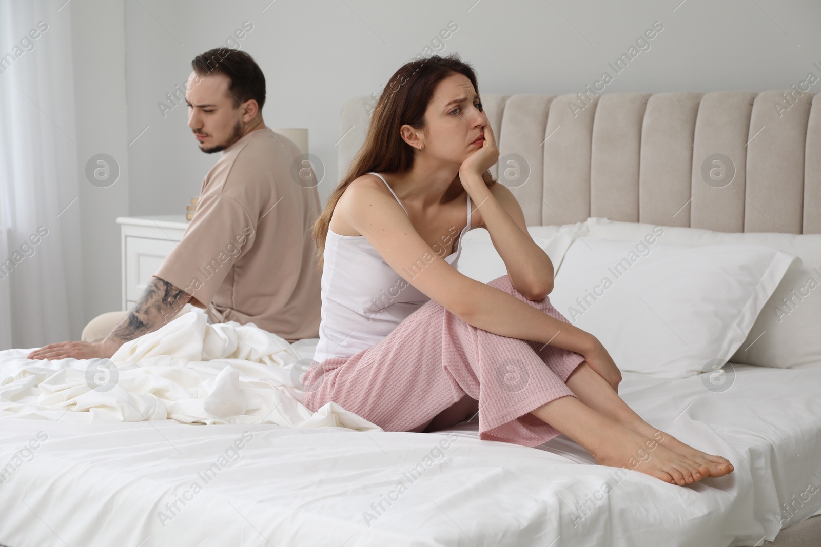 Photo of Offended couple after quarrel in bedroom. Relationship problem