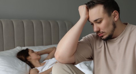 Photo of Offended couple after quarrel in bedroom. Relationship problem