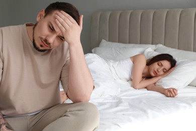 Photo of Offended couple after quarrel in bedroom. Relationship problem