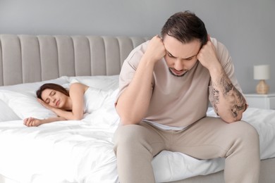 Photo of Offended couple after quarrel in bedroom. Relationship problem