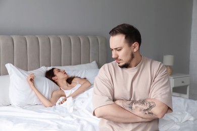 Offended couple after quarrel in bedroom. Relationship problem