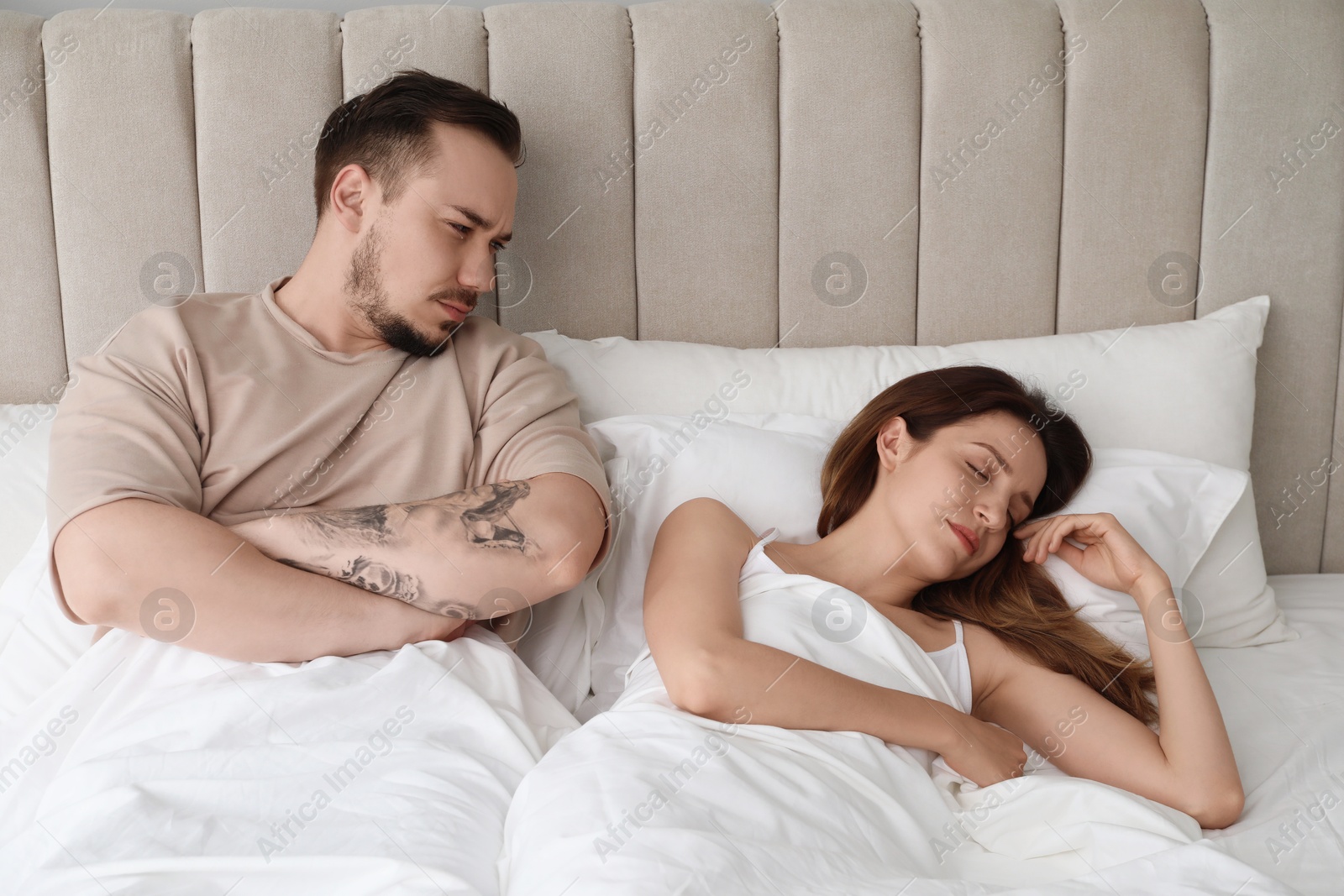 Photo of Offended couple after quarrel in bedroom. Relationship problem