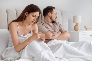 Offended couple after quarrel ignoring each other in bedroom. Relationship problem