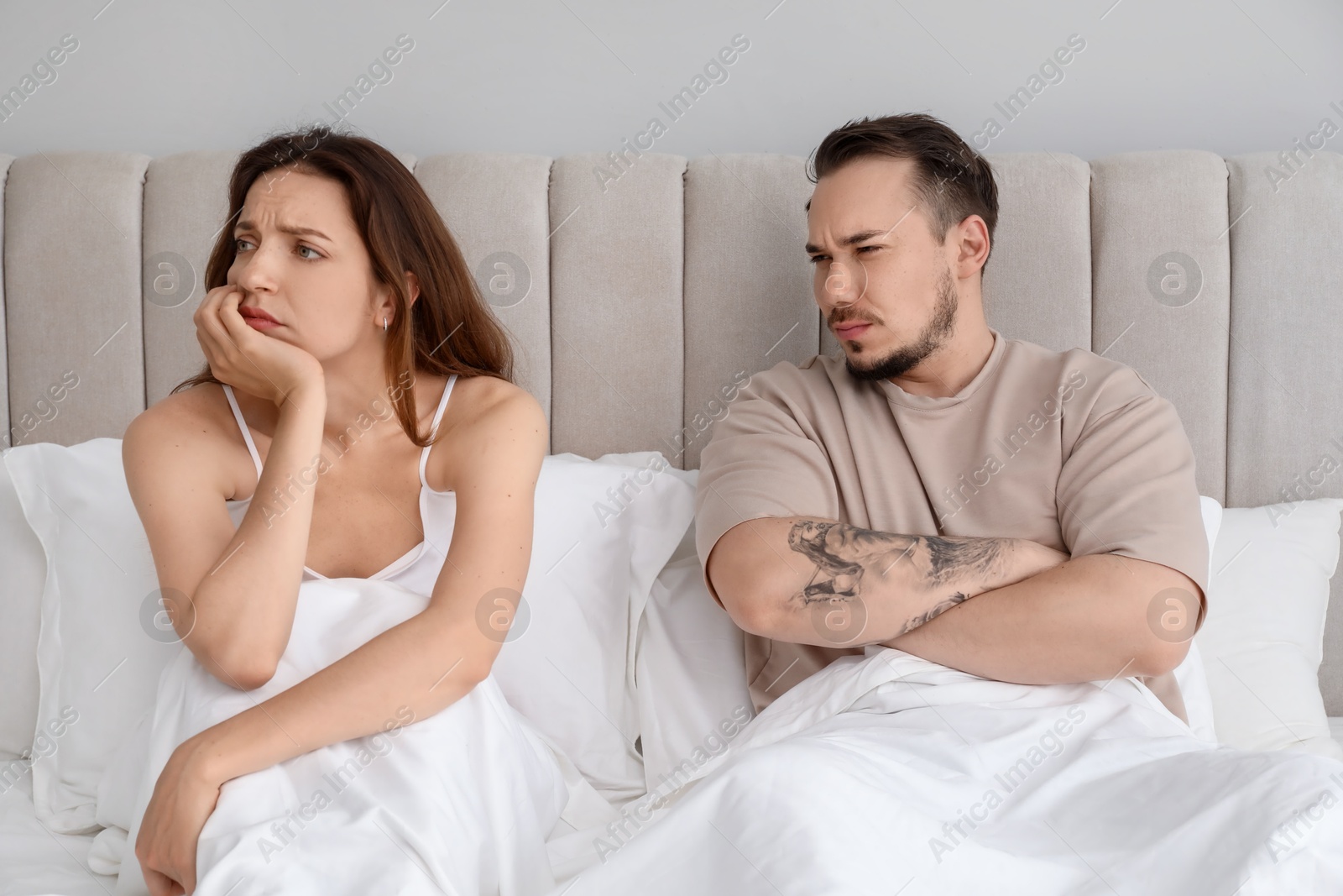 Photo of Offended couple after quarrel in bedroom. Relationship problem