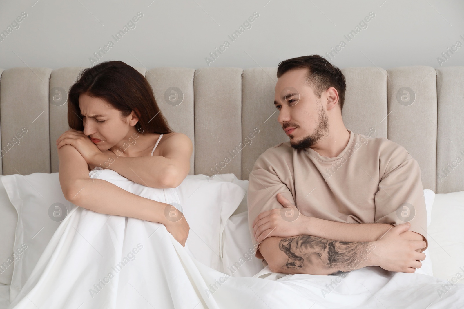 Photo of Offended couple after quarrel in bedroom. Relationship problem
