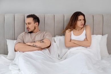 Offended couple after quarrel ignoring each other in bedroom. Relationship problem