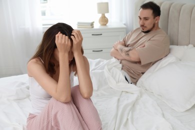 Offended couple after quarrel in bedroom. Relationship problem