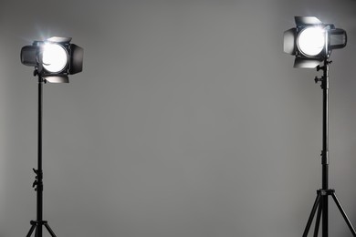 Photo of Grey photo background and professional lighting equipment in studio