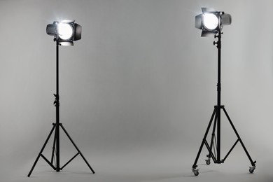 Grey photo background and professional lighting equipment in studio