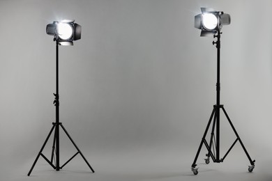 Photo of Grey photo background and professional lighting equipment in studio