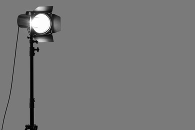 Photo of Grey photo background and professional lighting equipment in studio. Space for text