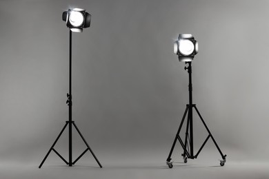 Grey photo background and professional lighting equipment in studio