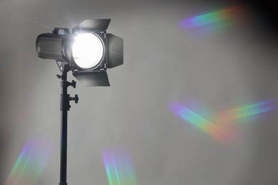 Photo of Grey photo background and professional lighting equipment in studio. Space for text