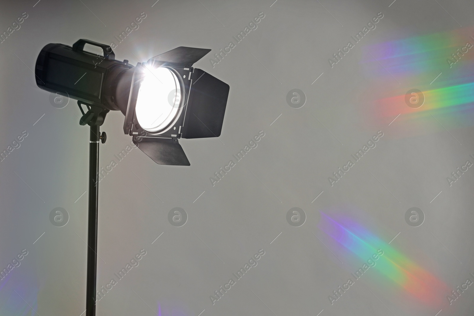 Photo of Grey photo background and professional lighting equipment in studio. Space for text