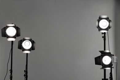 Grey photo background and professional lighting equipment in studio