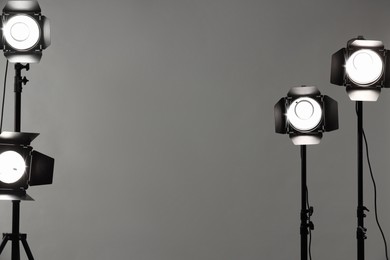 Photo of Grey photo background and professional lighting equipment in studio