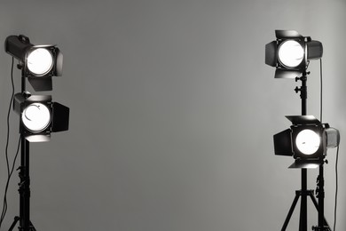 Photo of Grey photo background and professional lighting equipment in studio