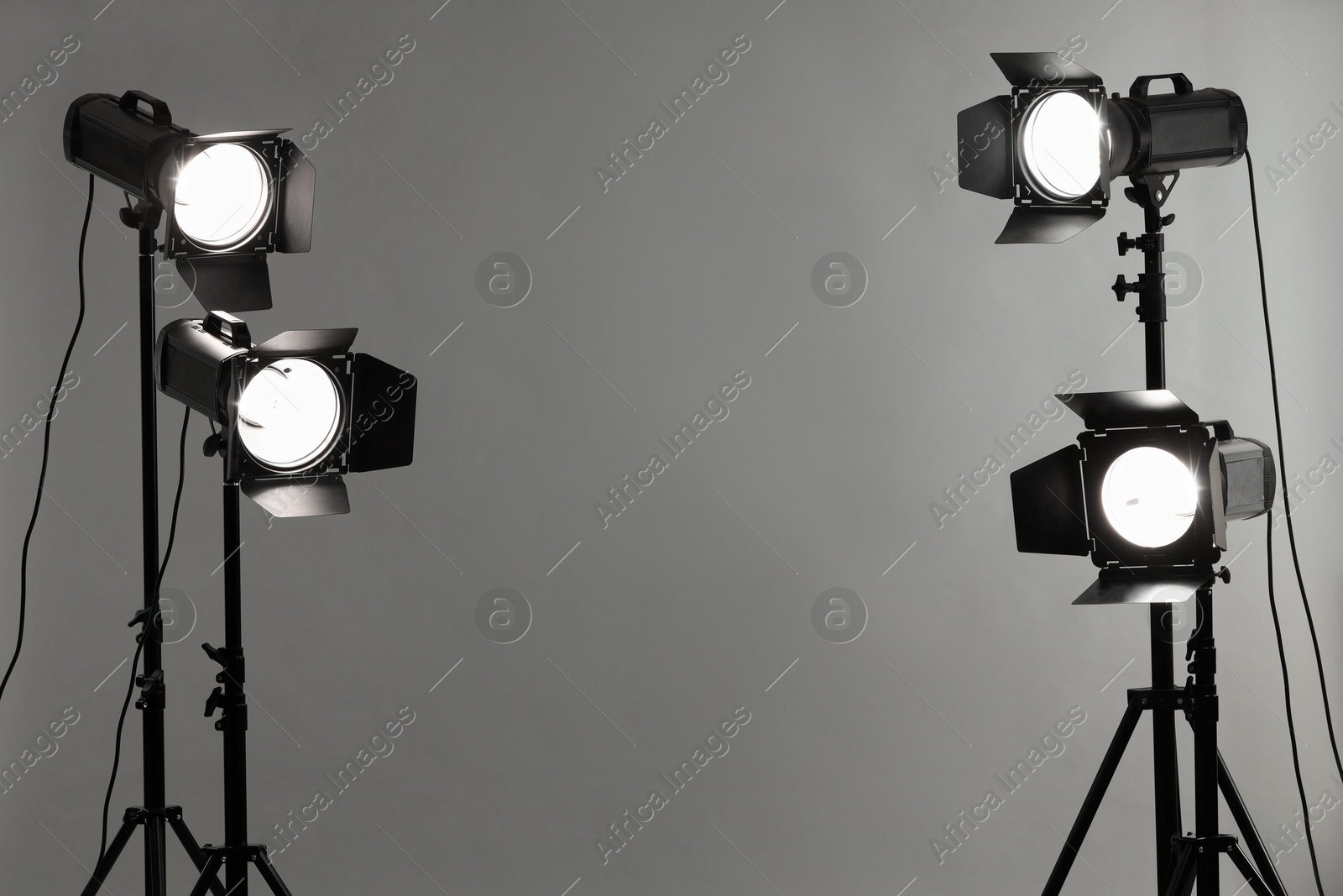 Photo of Grey photo background and professional lighting equipment in studio