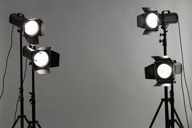 Grey photo background and professional lighting equipment in studio