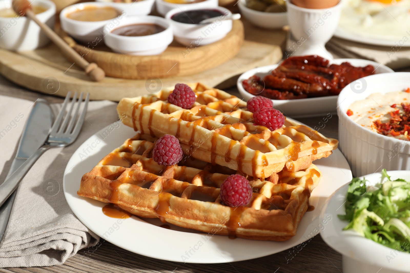 Photo of Different meals served for breakfast on wooden table