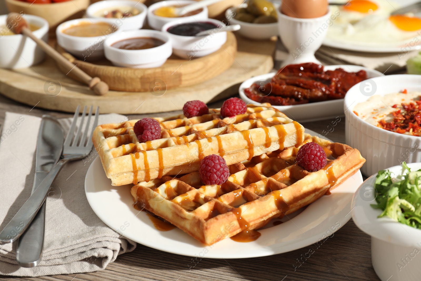 Photo of Different meals served for breakfast on wooden table