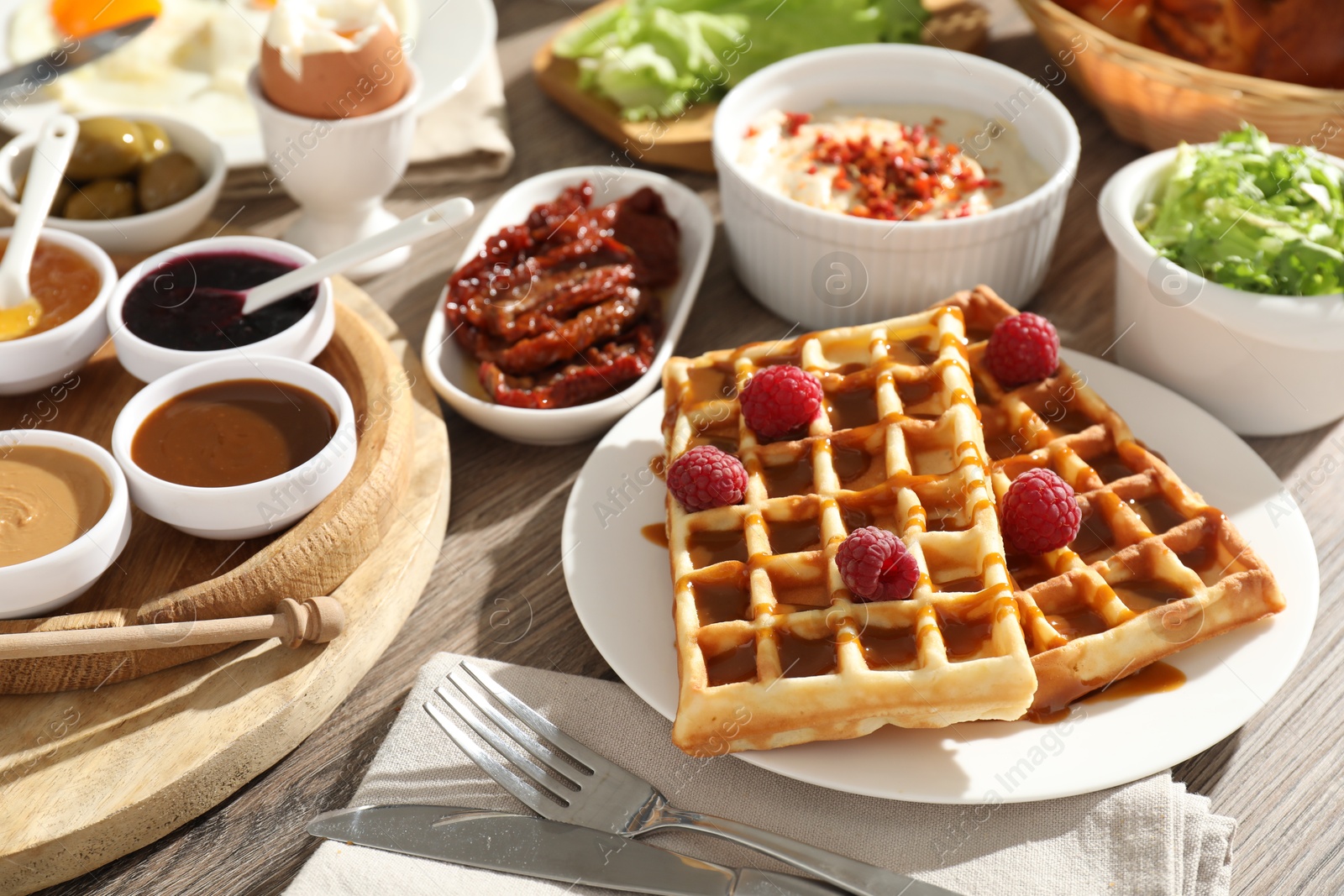 Photo of Different meals served for breakfast on wooden table