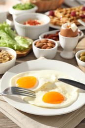 Photo of Different meals served for breakfast on wooden table