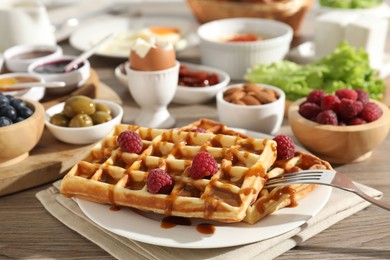 Photo of Different meals served for breakfast on wooden table