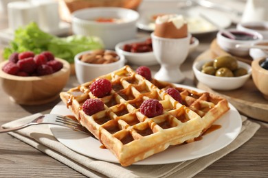 Photo of Different meals served for breakfast on wooden table