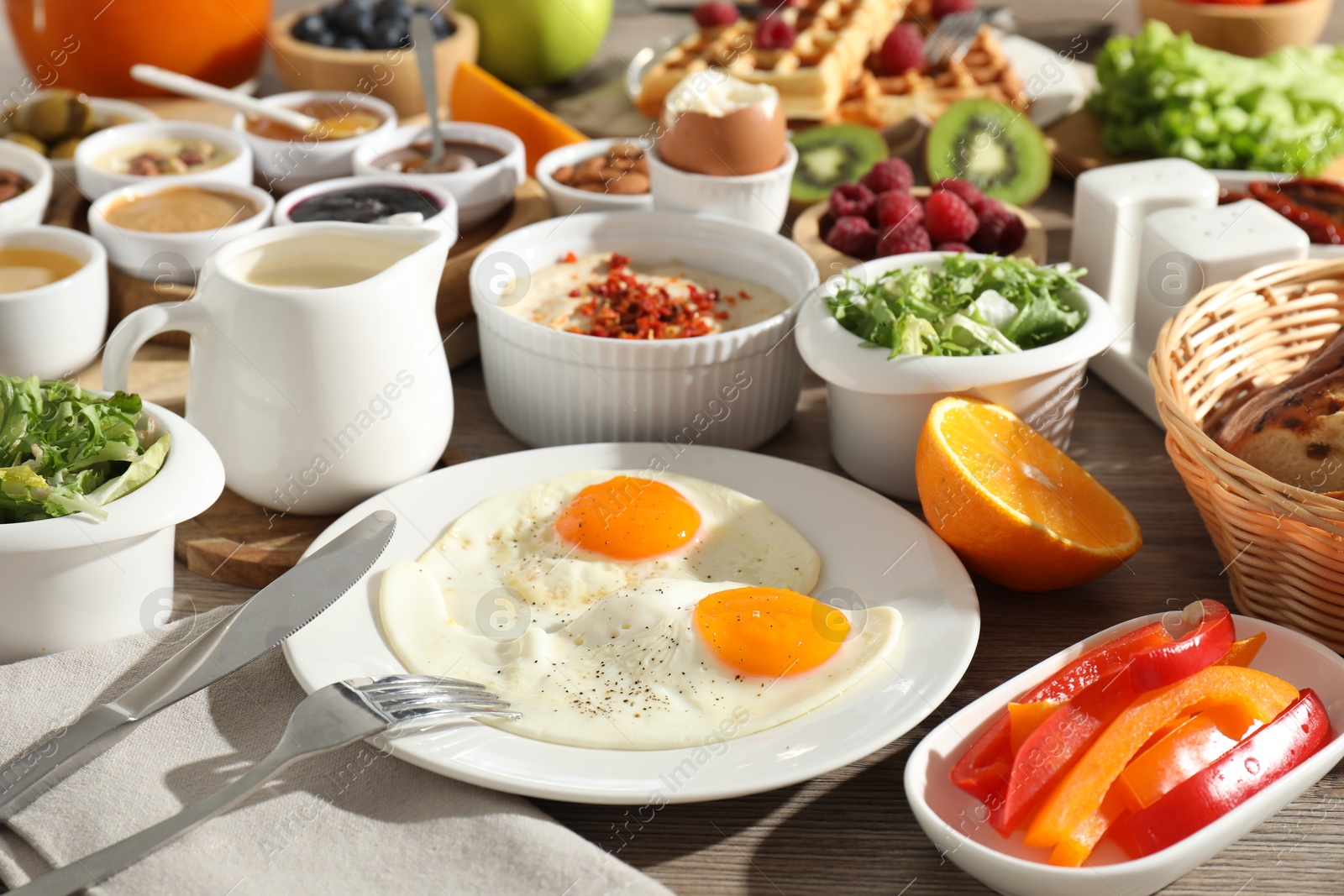 Photo of Different meals served for breakfast on wooden table