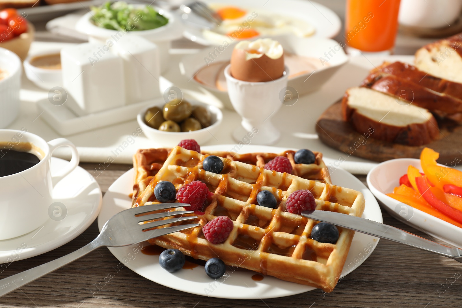 Photo of Different meals served for breakfast on wooden table