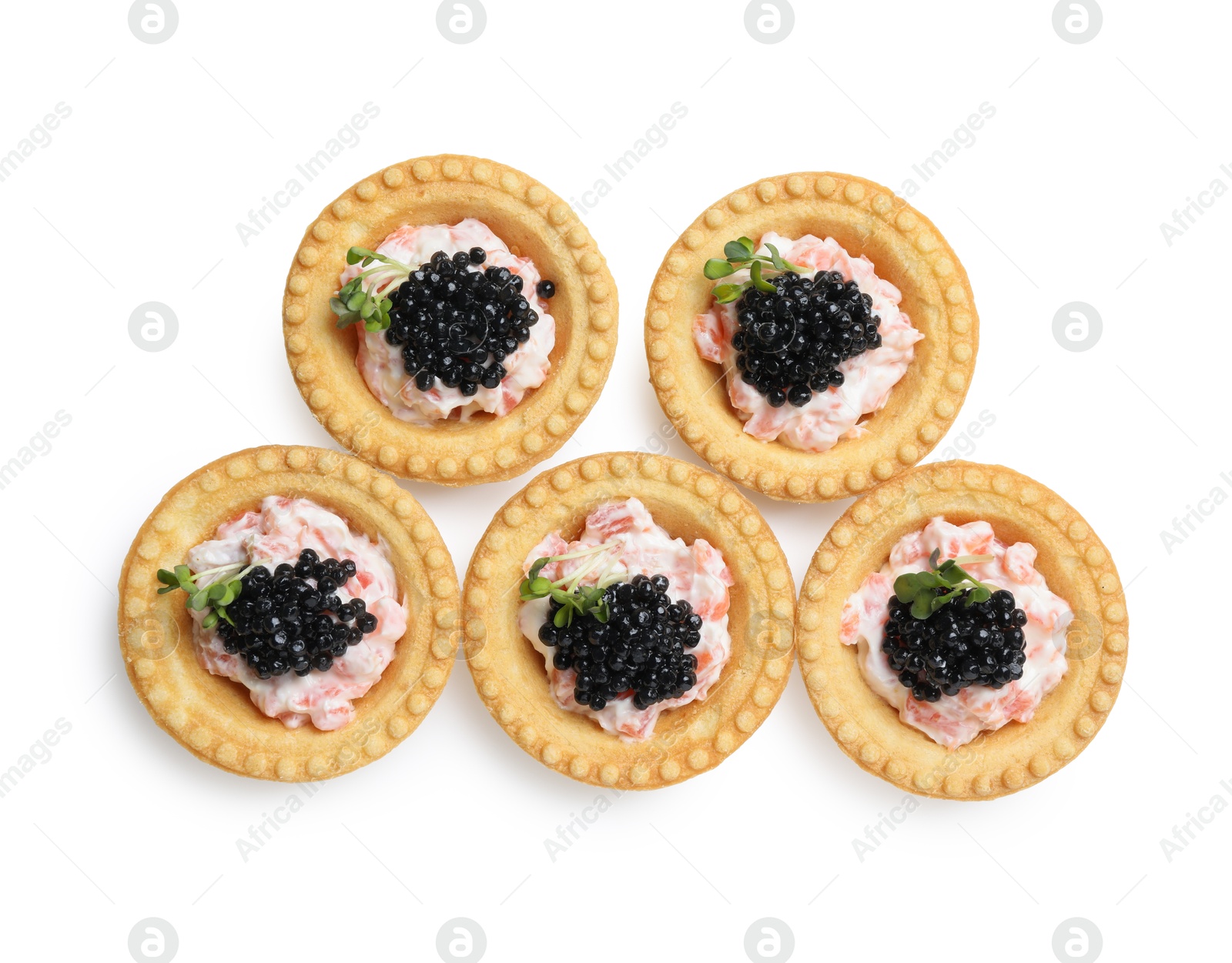 Photo of Delicious canapes with black caviar isolated on white, top view