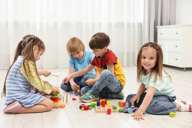 Group of children playing together on floor indoors