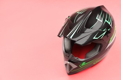 Modern motorcycle helmet with visor on red background. Space for text