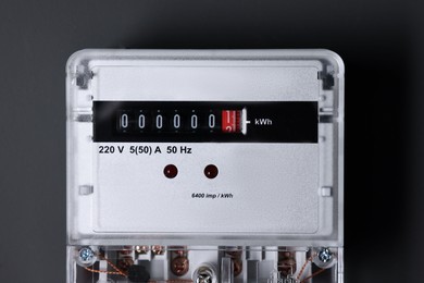 Photo of Electric meter on black background. Energy measuring device