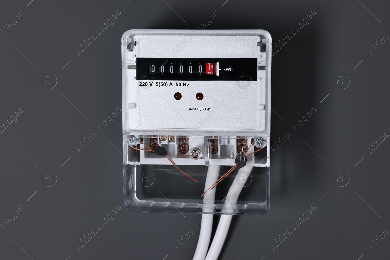 Photo of Electric meter on black background. Energy measuring device