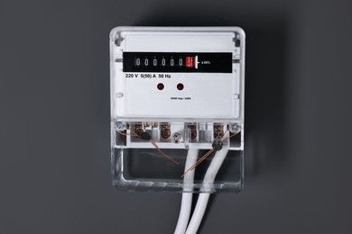 Photo of Electric meter on black background. Energy measuring device